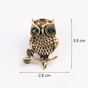 Vintage owl brooch with green rhinestone eyes and antique bronze finish, 3.8x2.8 cm size.
