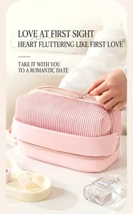 Close-up of pink pleated makeup bag with double layer design and zipper detail