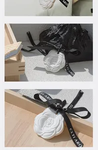 Detailed view of an elegant white rose plaster air freshener with a black ribbon