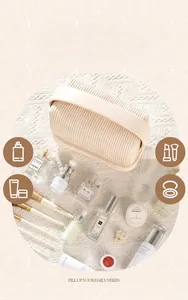 Close-up of minimalist cream pleated cosmetic bag surrounded by beauty skincare props.