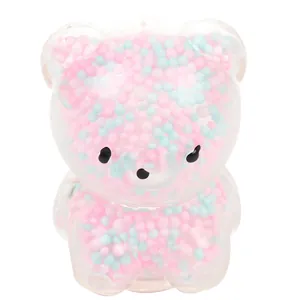Close-up of bear-shaped stress relief toy filled with pink and blue foam beads.