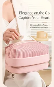 Detail view of pink pleated PU cosmetic bag with double-layer zipper design