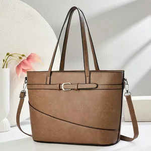 Elegant brown faux leather tote bag featuring a decorative buckle strap on the front