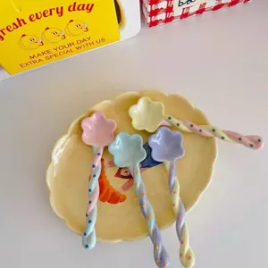 Set of 4 cute pastel ceramic stirring spoons with flower heads and twisted handles