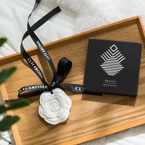 White camellia shaped plaster aroma diffuser stone with black hanging ribbon for wardrobe
