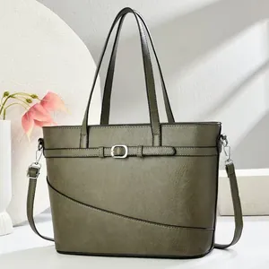 Olive green high-capacity fashionable tote bag with silver buckle detail and long strap.