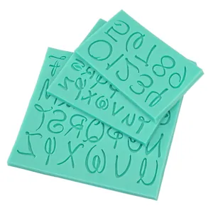 Macro detail showing teal alphanumeric silicone molds for cake decorating and chocolate DIY