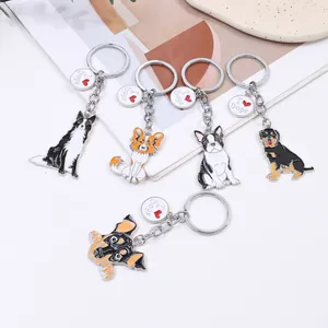 Detailed macro view of five cartoon dog keychains featuring various breeds and designs