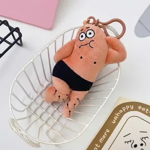 Close-up of a funny parody plush character keychain with hairy legs lying in a basket