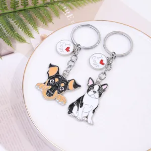 Detailed macro view of two zinc alloy cartoon dog keychains with I Love Dogs charms