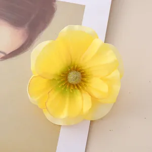 Close-up of a vibrant yellow artificial magnolia flower head with detailed petals.