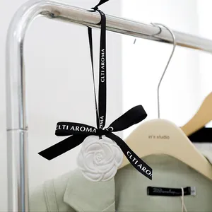 Elegant white camellia flower shaped plaster wardrobe fragrance hanger with a black ribbon loop