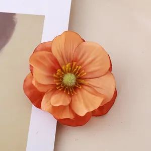 Detailed macro shot of a realistic orange artificial magnolia flower head for decor.