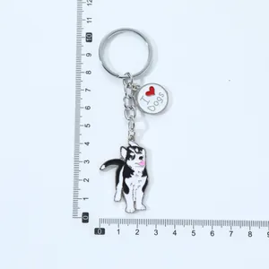 Detail shot of a cartoon husky keychain with a ruler showing it's about 10cm long.
