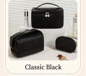 Detailed macro view of three classic black pleated PU leather travel makeup bags