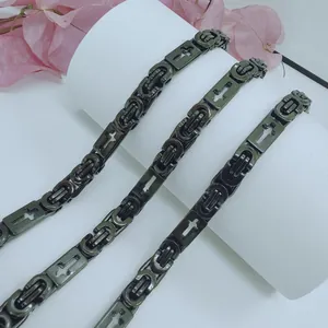 Close-up of black stainless steel Byzantine chain necklace with cross motifs