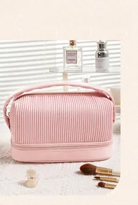 Detail of pink pleated cosmetic bag with double-layer design and handle