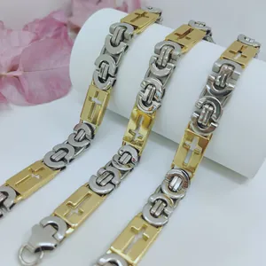 Detailed view of two-tone stainless steel men's chain with cross motifs.