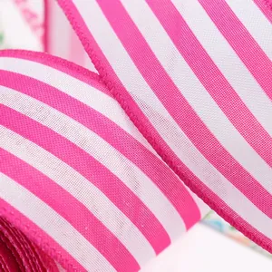 Close-up of pink and white striped wired edge ribbon for festive gift packaging and bows