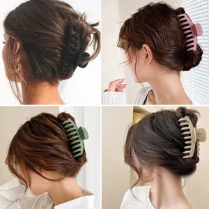 Four matte large hair claw clips in various colors for thick hair styling and updos