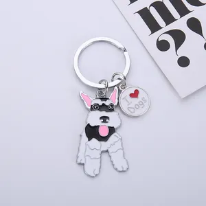Close-up detail of a cartoon Schnauzer dog keychain featuring an I Heart Dogs charm