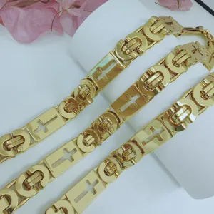Detailed view of a gold-plated stainless steel chain necklace with cross-shaped links