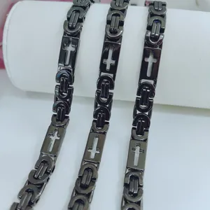 Detailed macro view of black stainless steel men's chains featuring hollow cross designs