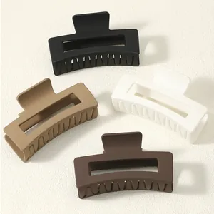 Group of four minimalist matte square hair claw clips in neutral earthy color tones