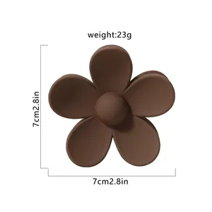 Detailed view of matte brown flower hair claw clip with 7cm size markings and 23g weight