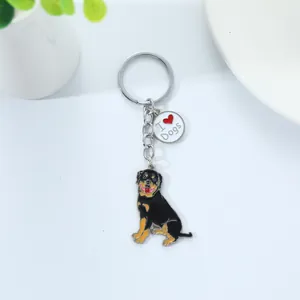 Detailed view of Rottweiler dog keychain with I Love Dogs tag on white surface backdrop