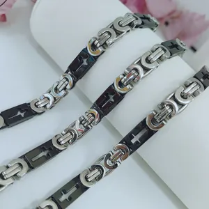 Macro view of men's stainless steel necklace featuring black and silver cross motif links
