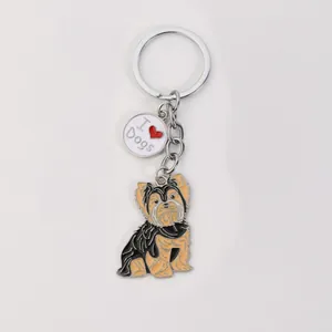 Close-up of a cute Yorkshire Terrier enamel keychain featuring an 'I Love Dogs' charm.