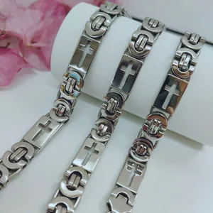 Close-up detail of stainless steel men's necklace with hollow cross and Byzantine links