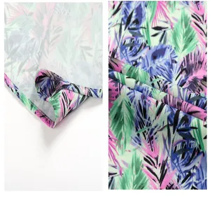 Close-up of tropical palm leaf print and hemline on men's beach shirt.