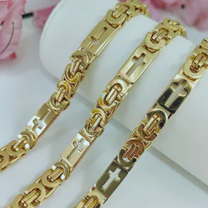 Macro detail of high-quality gold stainless steel Byzantine chain featuring cross motifs