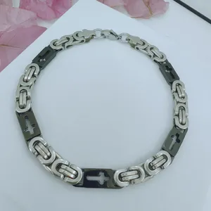 Detail view of a stainless steel men's Byzantine chain necklace with cross pattern
