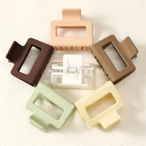 Detailed view of matte square hair claw clips in assorted pastel and earthy colors.