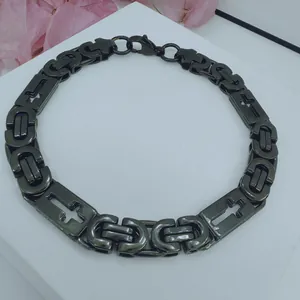 Detailed view of black stainless steel Byzantine chain necklace featuring cross motifs