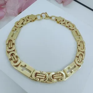 Detail view of gold-plated stainless steel necklace with hollow cross link design