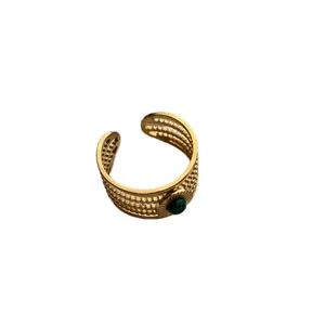 Vintage gold-toned adjustable ring with textured metal band and green gemstone