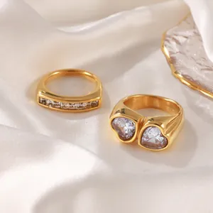 Elegant gold plated double heart and line zircon ring set on soft white silk fabric