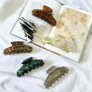 Close-up of assorted French acetate hair claws with marble and leopard patterns