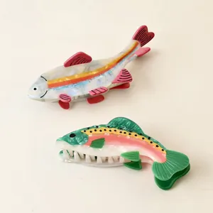 Detailed view of colorful fish-shaped acetate hair claw clips showing vibrant textures