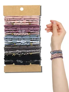 Close-up detail of bohemian style elastic hair ties and braided bracelets worn on wrist