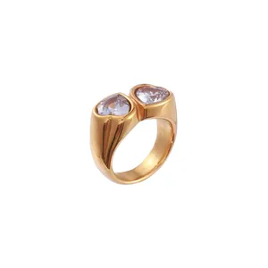Elegant gold-tone ring featuring two heart-shaped zircons with a polished finish