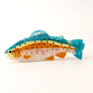 Close-up detail of a colorful fish-shaped hair claw made from premium acetate material.
