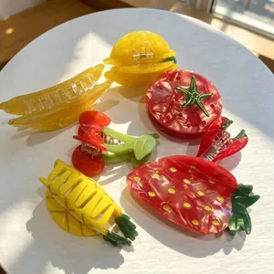 Vibrant fruit-themed acetate hair claws featuring strawberry and pineapple designs.