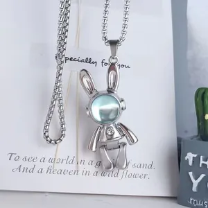 Detail view of the silver mechanical rabbit pendant with movable joints and chain.