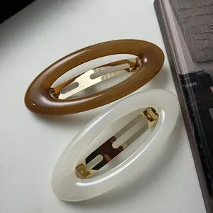 Vintage acrylic oval hair clips in brown and cream colors with gold metal spring clip