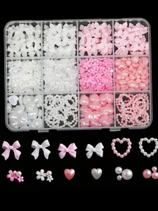 Detailed view of 12-grid nail art charms set featuring pink and white bows and pearls